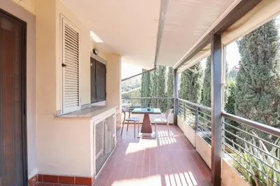 a balcony of a house with a table and chairs at Free Parking Chic Home - Balcony, AC, Wi-Fi in Rome