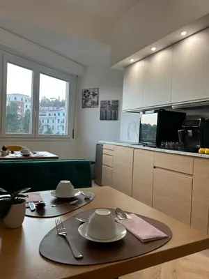 a kitchen with a table with plates and utensils on it at GLhouse Roma Mazzini in Rome