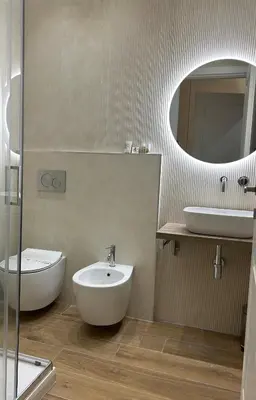 a bathroom with a sink and a toilet and a mirror at GLhouse Roma Mazzini in Rome