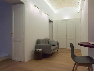 a living room with a chair and a couch at La Casa Di Iulia in Rome