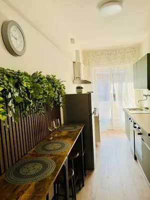 a kitchen with a counter with a table and a clock at Step to the Vatican in Rome