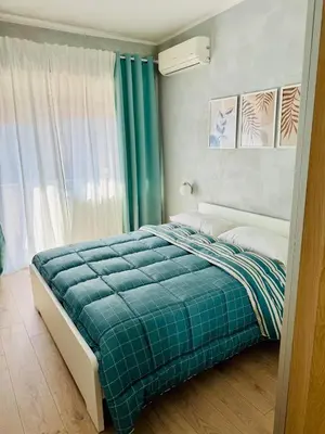 a bedroom with a bed with a blue blanket at Step to the Vatican in Rome