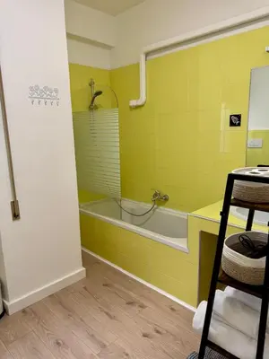 a yellow bathroom with a tub and a sink at Step to the Vatican in Rome