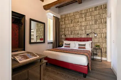 a hotel room with a bed and a desk at Maison Evelina in Rome