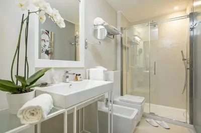 a white bathroom with a sink and a toilet at Maison Evelina in Rome