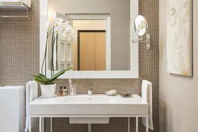 a bathroom with a white sink and a mirror at Maison Evelina in Rome