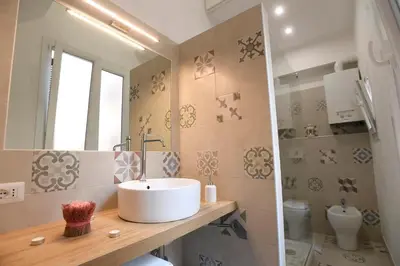 a bathroom with a sink and a toilet at Il Mattoncino - Colosseo in Rome