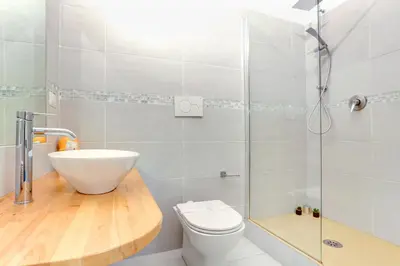 a bathroom with a toilet and a glass shower at Il Mattoncino - Colosseo in Rome