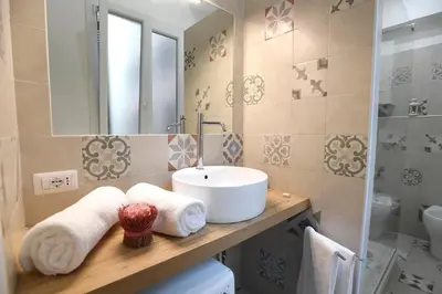 a bathroom with a sink and a mirror at Il Mattoncino - Colosseo in Rome