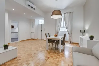 a living room with a table and a dining room at Vantaggio Apartment in Rome
