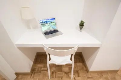 a white desk with a laptop on top of it at Vantaggio Apartment in Rome