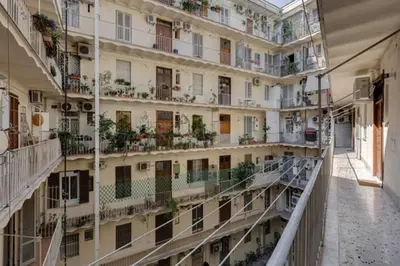 an empty hallway of an apartment building with balconies at Vantaggio Apartment in Rome