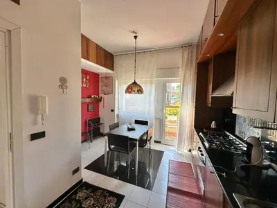 a kitchen with a table and a dining room at Penthouse Luxe - Rome in Rome