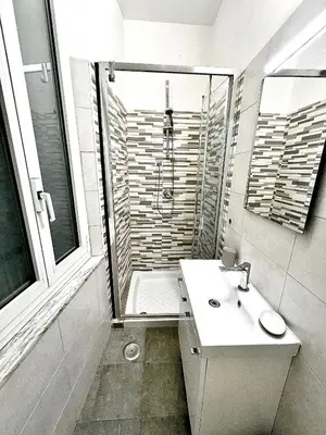 a white bathroom with a sink and a shower at Minerva Pantheon Suites in Rome