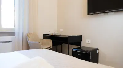 a bedroom with a desk and a bed and a desk at Suites 215 Colosseum - Guesthouse in Rome