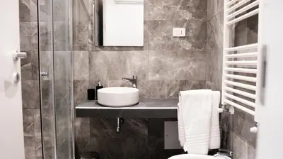 a bathroom with a sink and a toilet at Suites 215 Colosseum - Guesthouse in Rome