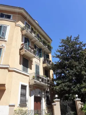 a building with balconies and a tree in front of it at Loft Capodistria, Rome, in Rome