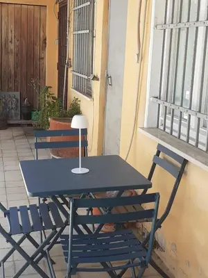 a table and two chairs sitting next to a window at Loft Capodistria, Rome, in Rome