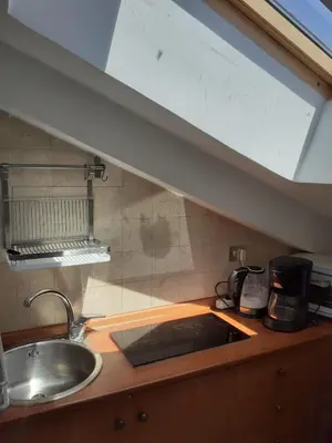 a kitchen with a sink and a counter top at Loft Capodistria, Rome, in Rome