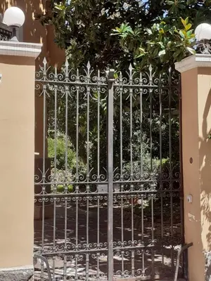 a black gate with a bench in front of it at Loft Capodistria, Rome, in Rome