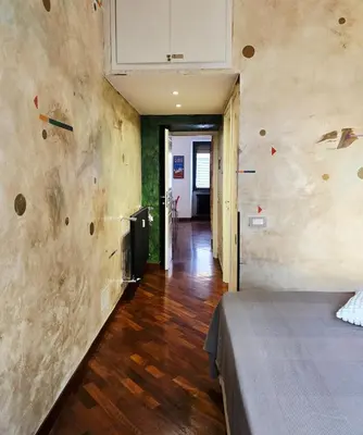 a room with a bed and a hallway at Conte Apartment - Roma San Pietro in Rome