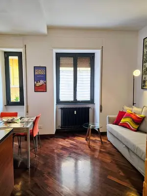 a living room with a couch and a table at Conte Apartment - Roma San Pietro in Rome
