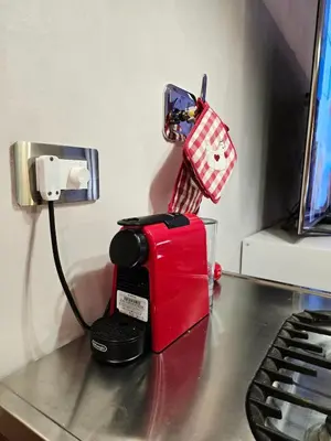 a red toaster sitting on top of a desk at Conte Apartment - Roma San Pietro in Rome