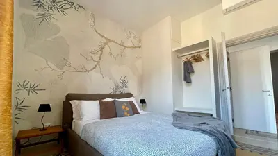 a bedroom with a bed with a blue comforter at Santonofrio SKY Terrace Penthouse in Rome