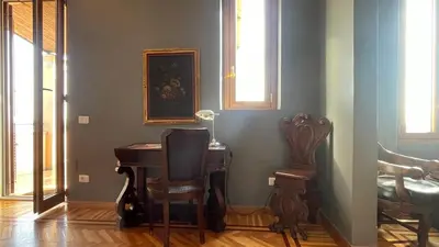 a room with a piano and a chair and a lamp at Santonofrio SKY Terrace Penthouse in Rome