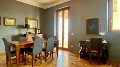 a dining room with a table and chairs at Santonofrio SKY Terrace Penthouse in Rome