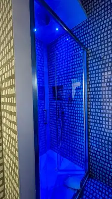 a bathroom with a shower with blue lights at Santonofrio SKY Terrace Penthouse in Rome