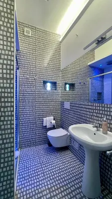 a bathroom with a white sink and a toilet at Santonofrio SKY Terrace Penthouse in Rome