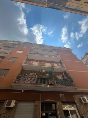 a building with a balcony on the side of it at SR Guesthouse in Rome
