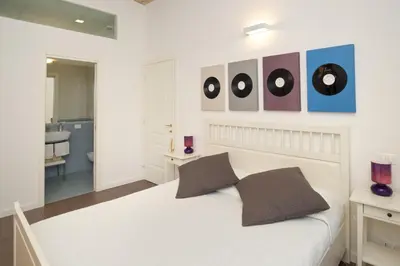 a bedroom with a white bed with two pillows at Germanico Maxi in Rome