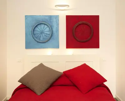 a bedroom with three pictures on the wall above a bed at Germanico Maxi in Rome