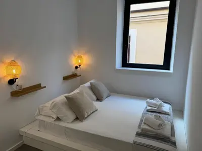 a white bed with two pillows and a window at Rome design and fitness stay - Pantheon and Trevi in Rome