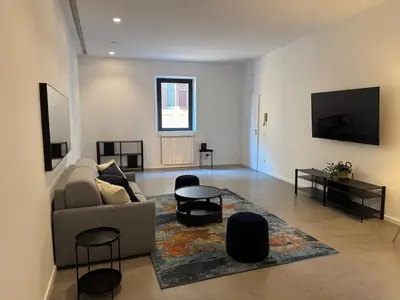 a living room with a couch and a tv at Rome design and fitness stay - Pantheon and Trevi in Rome