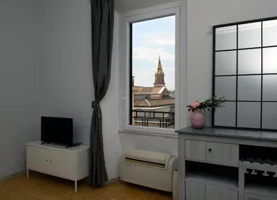 a room with a window with a view of a building at A due passi dal Colosseo - Vista città - Luxury in Rome