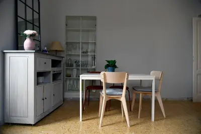 a dining room with a white table and chairs at A due passi dal Colosseo - Vista città - Luxury in Rome