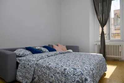 a bedroom with a bed with a blue blanket at A due passi dal Colosseo - Vista città - Luxury in Rome
