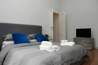 a bedroom with a large bed with towels on it at A due passi dal Colosseo - Vista città - Luxury in Rome