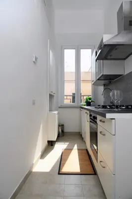 a kitchen with white appliances and a large window at A due passi dal Colosseo - Vista città - Luxury in Rome