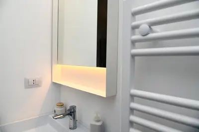 a bathroom with a sink and a mirror at A due passi dal Colosseo - Vista città - Luxury in Rome