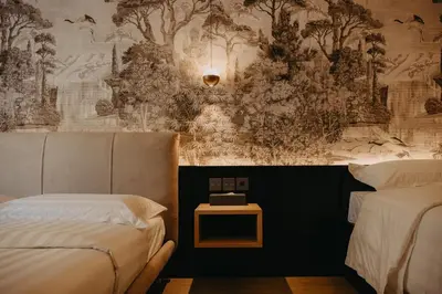 a bedroom with two beds and a wall with trees at Guest House Praesidium in Rome