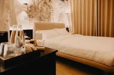 a bedroom with a bed and a dresser with a nightstanduments at Guest House Praesidium in Rome