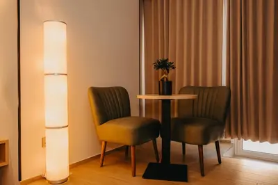 a hotel room with two chairs and a table with a plant on it at Guest House Praesidium in Rome