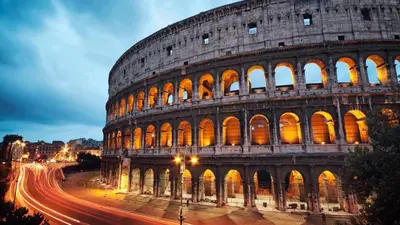 a night view of the colosseum at night at Historic 3BR Colosseum Apartment 160sqm for 9 in Rome