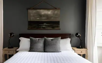 a bedroom with a bed with pillows and a painting at Historic 3BR Colosseum Apartment 160sqm for 9 in Rome