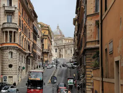 a busy city street with cars and a bus at Historic 3BR Colosseum Apartment 160sqm for 9 in Rome