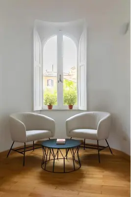 a living room with two white couches and a window at Historic 3BR Colosseum Apartment 160sqm for 9 in Rome
